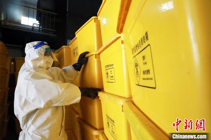 圖為工作人員搬運(yùn)醫(yī)療廢物專用周轉(zhuǎn)箱。　魏建軍 攝