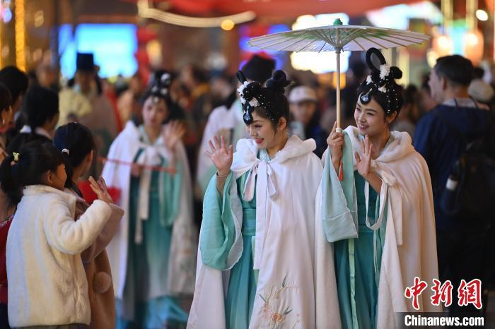 圖為街區(qū)人員著傳統(tǒng)服飾與游人互動。李亞龍 攝</p><p>